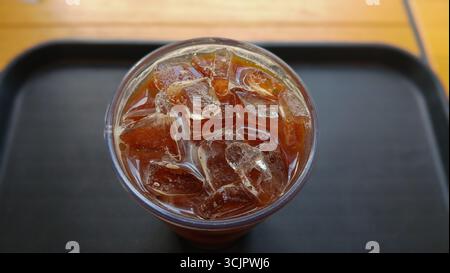 A refreshing glass of iced coffee placed on a table Stock Photo