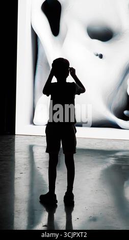 Izmir, Turkey. 07th Sep, 2025. An immersive art exhibition by world-renowned new media artist Refik Anadol, featuring his works “Perception of Healing” and “Machine Dreams: Aegean.” Visitors are silhouetted against large-scale digital installations, where artificial intelligence transforms human brain data and Aegean Sea environmental data into vibrant, dynamic visual experiences. The exhibition highlights the intersection of art, science, and technology, creating empathy and a sensory connection with nature. Credit: İdil Toffolo/Ģ����ý Live News Stock Photo