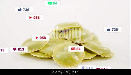 Displaying pile of green ravioli sitting on studio counter, with social media icon overlays Stock Photo