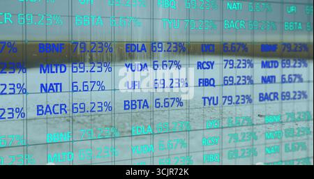 Displaying glass panel showing alphanumeric codes with percentages inside building, digital display Stock Photo