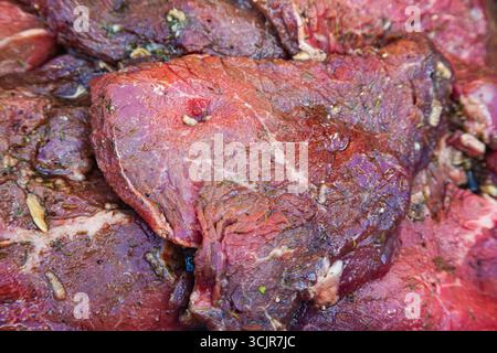 Pieces of juicy, fresh beef in spices, close-up. Beef raw steaks, top view. Stock Photo