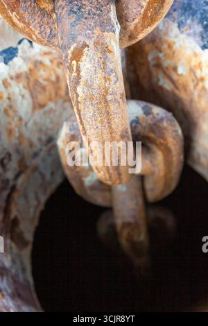 Ship's anchor chain in the anchor hawse on the ship, close-up. Stock Photo