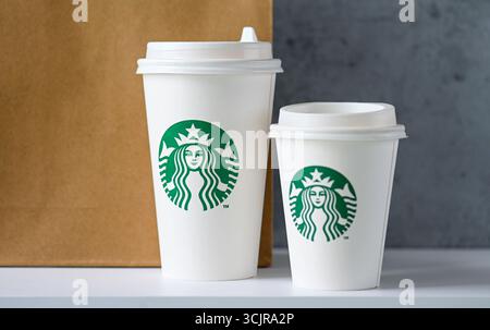 BERLIN - AUG 16: Starbucks paper cups with logotype on a table in Berlin on August 16. 2025, Germany Stock Photo
