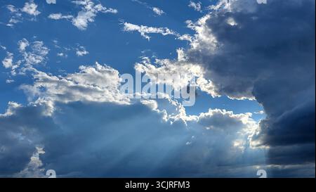 Dramatic cloud formations showcasing strong contrasts and various shades from white and gray to nearly black Stock Photo