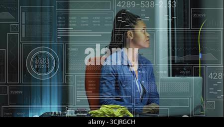 Technician wearing shirt and badge, plugging cables and typing on laptop in server room, copy space Stock Photo
