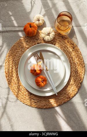 Autumn Table Setting with Decorative Pumpkins and Seasonal Leaves Stock Photo