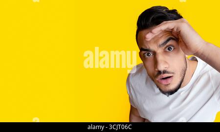 Top view of surprised middle eastern guy looking at camera Stock Photo