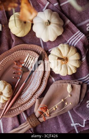 Rustic autumn table decor with pumpkins and stylish tableware Stock Photo