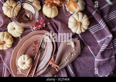 Warm fall tablescape with pumpkins and elegant holiday decor Stock Photo