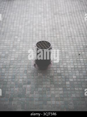 Abstract Image Of A Round Vent Or Grease Pipe Protruding From A Tiled Wall Surface Stock Photo