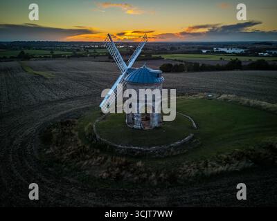 Aerial view of Chesterton Windmill in Warwickshire, England, during a beautiful sunset, creating a picturesque rural landscape Stock Photo