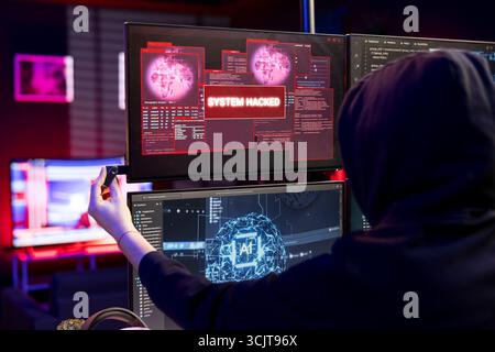 Hacker targets systems with virus infected USB, getting system hacked popup alert on display. Evil man uses USB stick to compromise networks, hiding online activity after stealing data Stock Photo