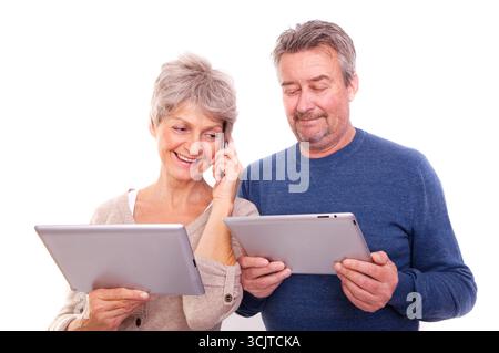 senior couple with tablets and mobile phones Stock Photo