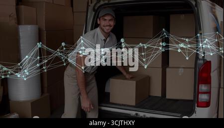Lifting worker in uniform lifting box at van loading dock, with bubble wrap and cardboard boxes Stock Photo