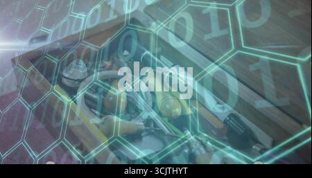 Displaying open wooden toolbox on bench with assorted hand tools, hex and binary digits overlay Stock Photo
