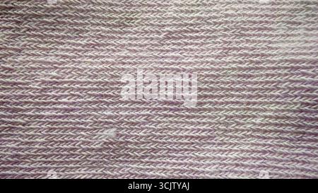 Subtle beige knitted fabric texture showing a detailed, seamless, horizontal ribbed pattern in a close-up macro view, ideal for backgrounds Stock Photo