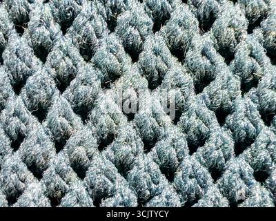Woven Texture of Blue Mesh Fabric, a Close-up of a Shoe's Breathable Material with a Repeating Diamond Pattern. Stock Photo