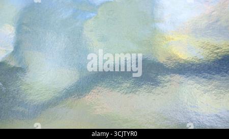 Iridescent silver foil paper texture, abstract festive background with pastel colors Stock Photo