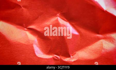 Crimson red metallic foil background, a crumpled and wrinkled paper texture Stock Photo