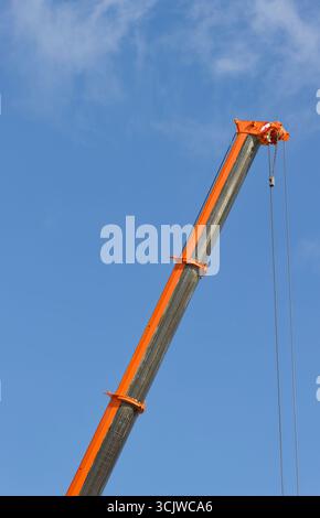 Orange mobile telescopic crane boom elevated and extended on Bury flexi hall construction site in greater manchester uk Stock Photo