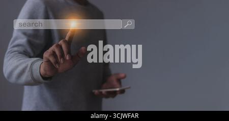 Young man with smartphone mobile hand touching search bar, Search job Stock Photo