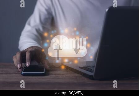 Young man with computer notebook and smartphone mobile hand touching to cloud computing diagram, Data storage, Cloud technology, Cloud Computing Stora Stock Photo