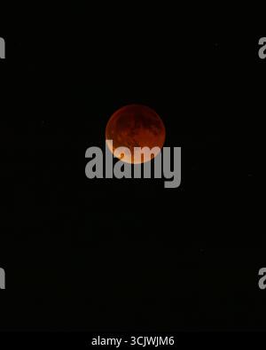 Aerial view of a blood moon glows with ethereal light against the inky canvas of the night sky, casting an eerie, beautiful spell, Chania, Chania, Greece. Stock Photo