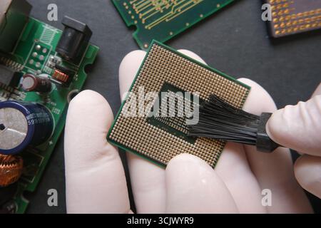 Maintenance of micro electronic components. Digital elements with semiconductor. Preparing the CPU for use. Central Processor Unit on the technician h Stock Photo