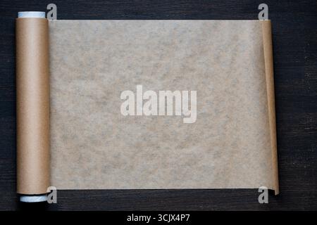 Roll of baking paper on wooden background, close up, top view, copy space Stock Photo