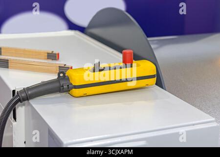 Wired Remote Control Machine With Emergency Stop Button in Factory Stock Photo