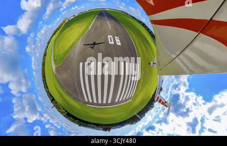 Aerial view, runway at Essen/Muelheim airport, shadow of an aeroplane on the runway, earth sphere, fisheye image, 360 degree image, tiny world, little Stock Photo
