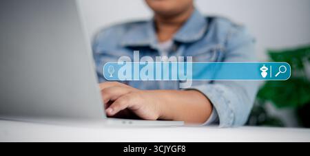 Close up of person typing on laptop with AI search bar interface, concept of voice search, chatbot technology, and artificial intelligence in online b Stock Photo