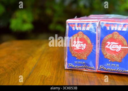 Tegal, Indonesia - April 27, 2024: Closeup photo of Jasmine tea produced from Tegal City, Indonesia under the brand 2 Tang Super Premium on a wooden t Stock Photo