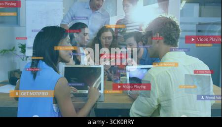 Collaborating office team exploring floating interface graphics in conference room, with laptops Stock Photo