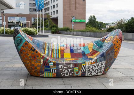 Colorful, mosaic-covered public bench with geometric and abstract patterns by Czech artist Alexandra Koláčková - Prague, Czech Republic Stock Photo