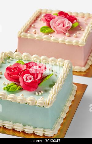 Delicious square cakes decorated with fondant roses and pearls Stock Photo