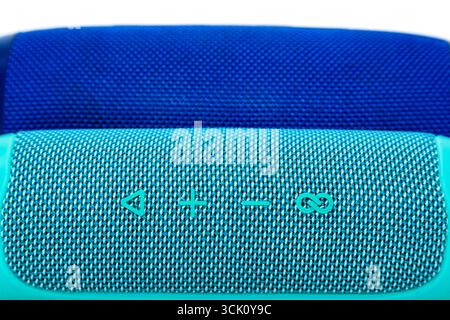 Two new wireless speakers on a white background, one turquoise and the other blue. Stock Photo