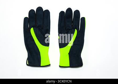 Protective work gloves on a white background, green - black with black leather and green synthetic material. Stock Photo