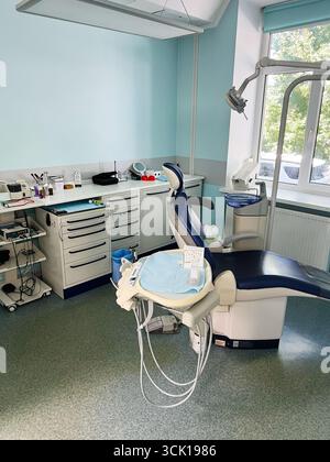 Dental clinic room featuring advanced tools and a patient chair under natural lighting Stock Photo