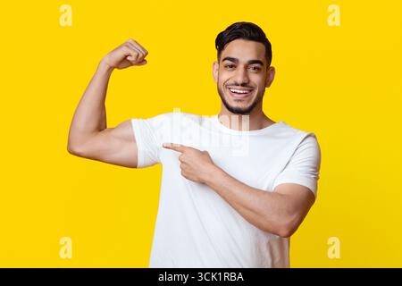 Athletic middle eastern man showing his muscles Stock Photo