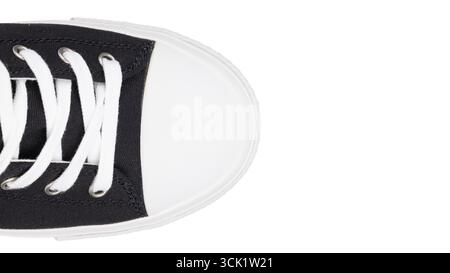 Close up of black canvas sneaker toe with white laces Stock Photo