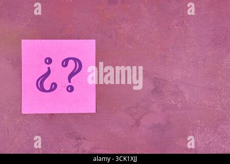 Question marks on sticky notes on a maroon background with copy Stock Photo