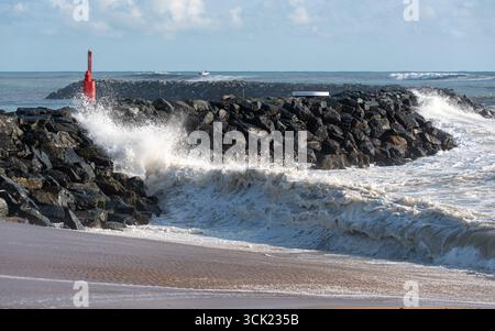 Big waves breaking on the seawall at La Cotinière beach on Oléron island. Stock Photo