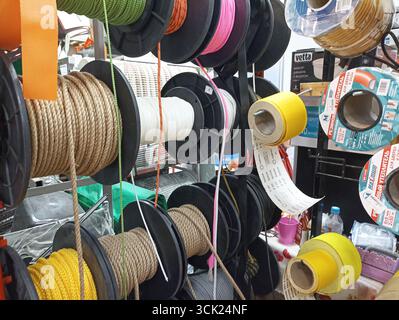 Variety of colored ropes and cables on display in a hardware store. Stock Photo