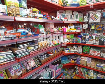 Wide variety of stationery supplies on red shelves in a store. Stock Photo