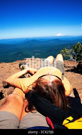 A couple relax along a hiking trail in the Columbia River gorge, Oregon. Stock Photo
