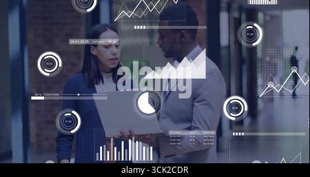 Analyzing metrics by professionals wearing suits in office corridor, with laptop and data overlays Stock Photo