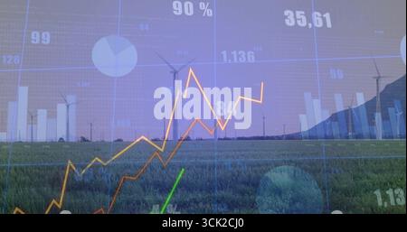 Onshore wind turbines projecting energy data overlay on rural grassy field, with charts and graphs Stock Photo