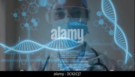 Observing masked researcher wearing goggles and lab coat in lab, analyzing DNA helix on hologram Stock Photo