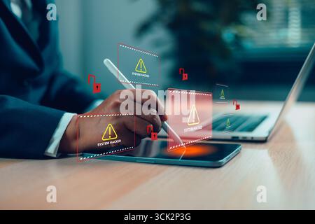 Businessman using digital tablet with system hacked alert on virtual screen, concept of cybersecurity breach, data theft, malware attack, online fraud Stock Photo